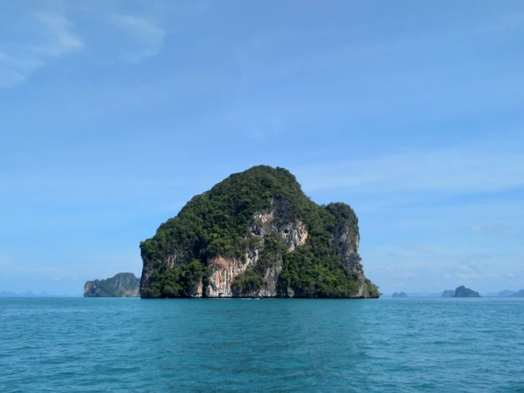 an island surrounded by the ocean on a clear day