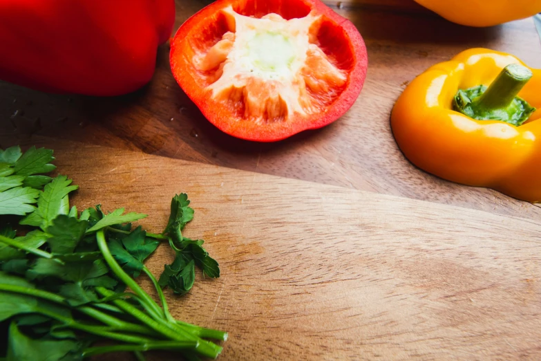 fresh peppers, basil and lime on a  board