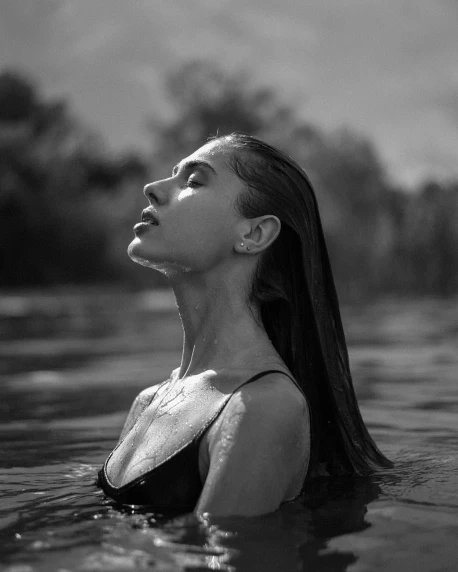 black and white pograph of a woman floating in water