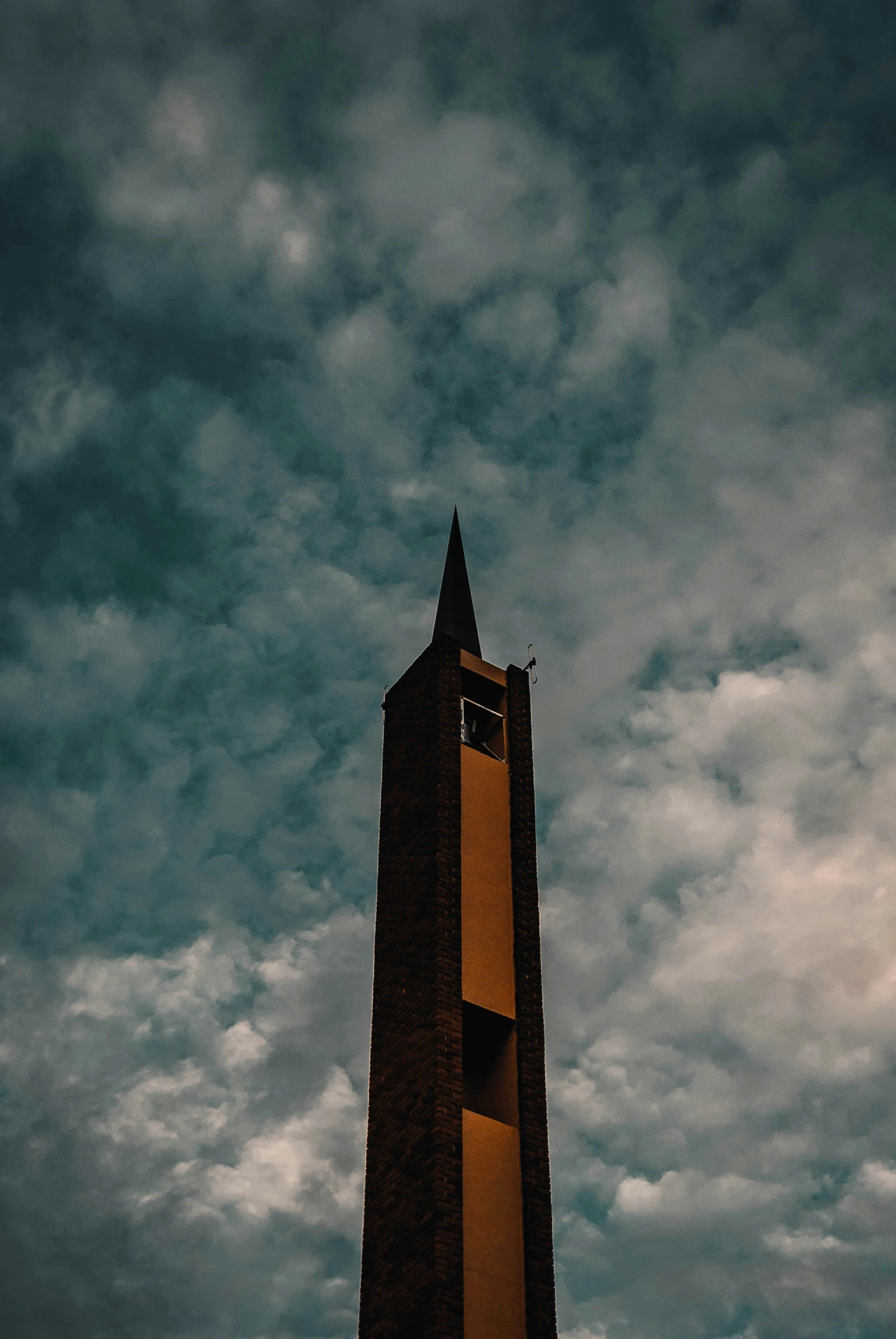 a tall brown building on a cloudy day