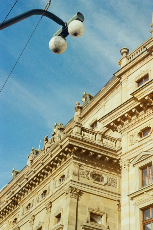 a street light is on in front of a large building