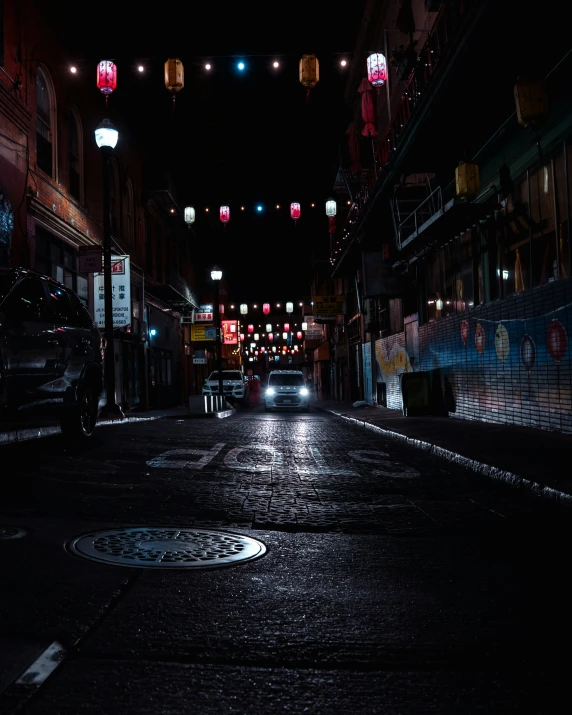dark empty street illuminated with colorful lanterns