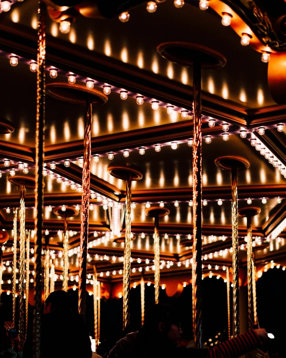 a night time scene of lights and poles