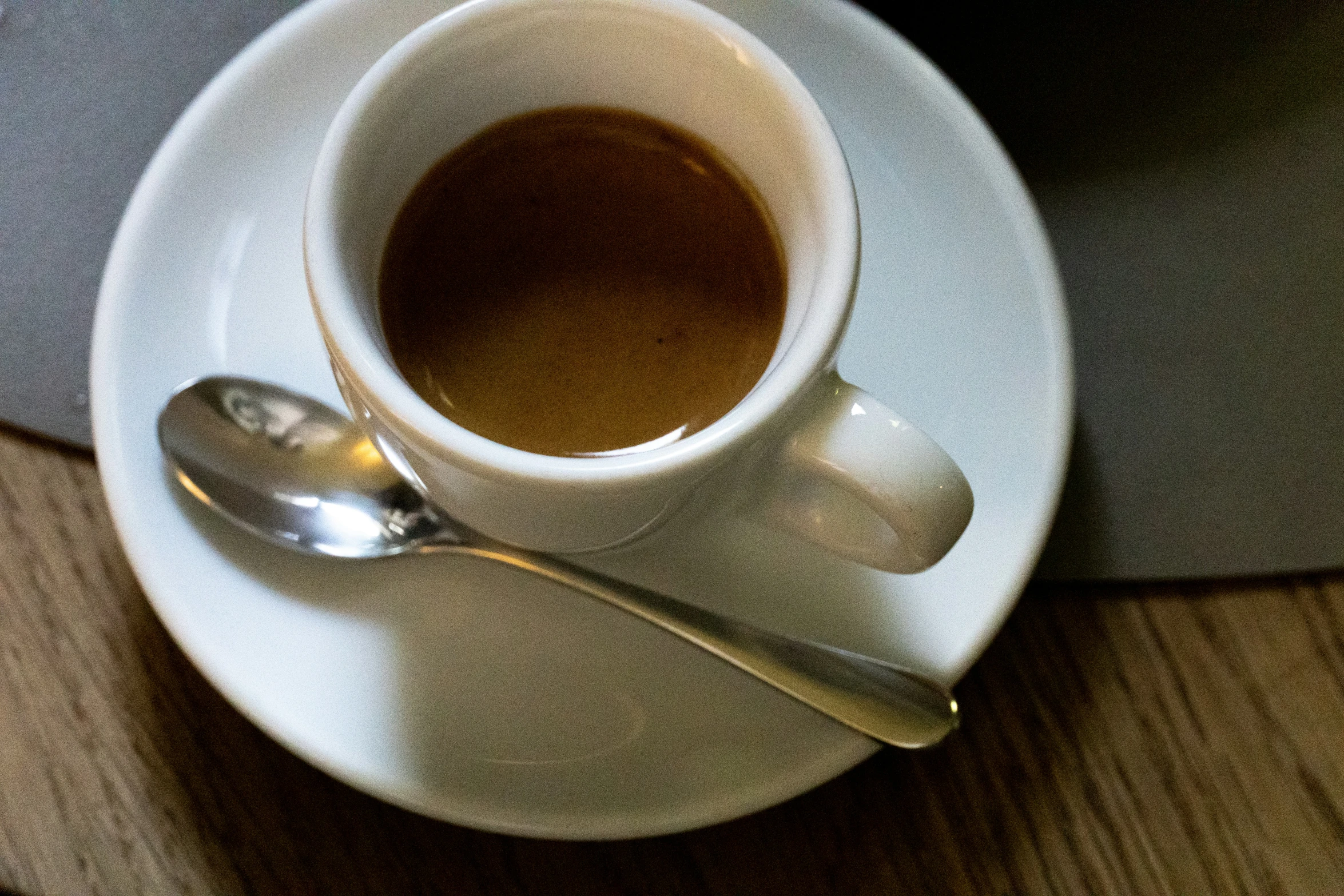 a cup of coffee is sitting on a plate