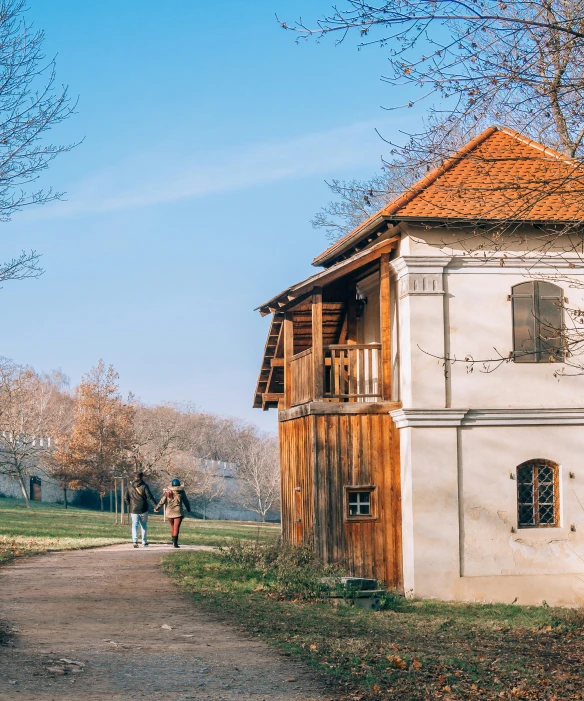 an old style building in the countryside near a dirt road