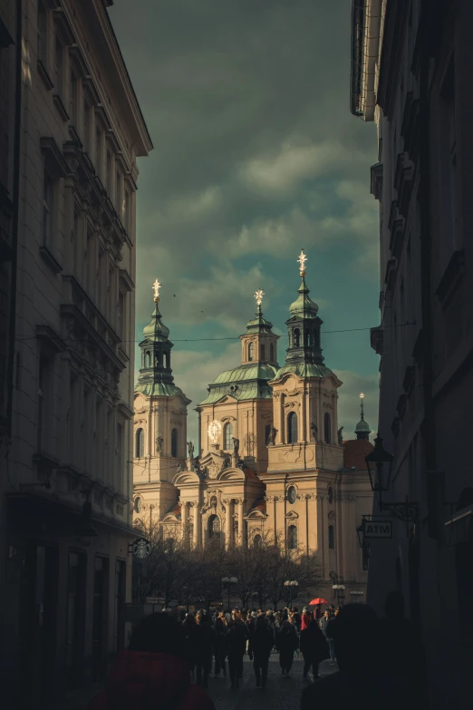 a castle is in the distance as pedestrians walk