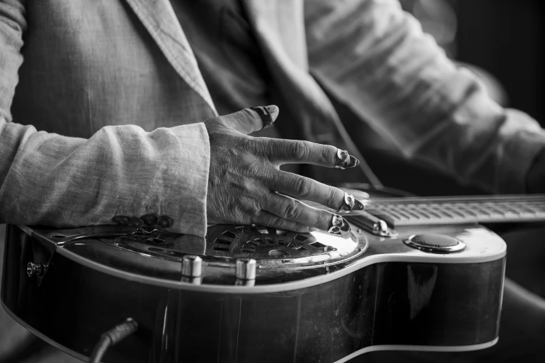 a woman playing an instrument with her hands on the top