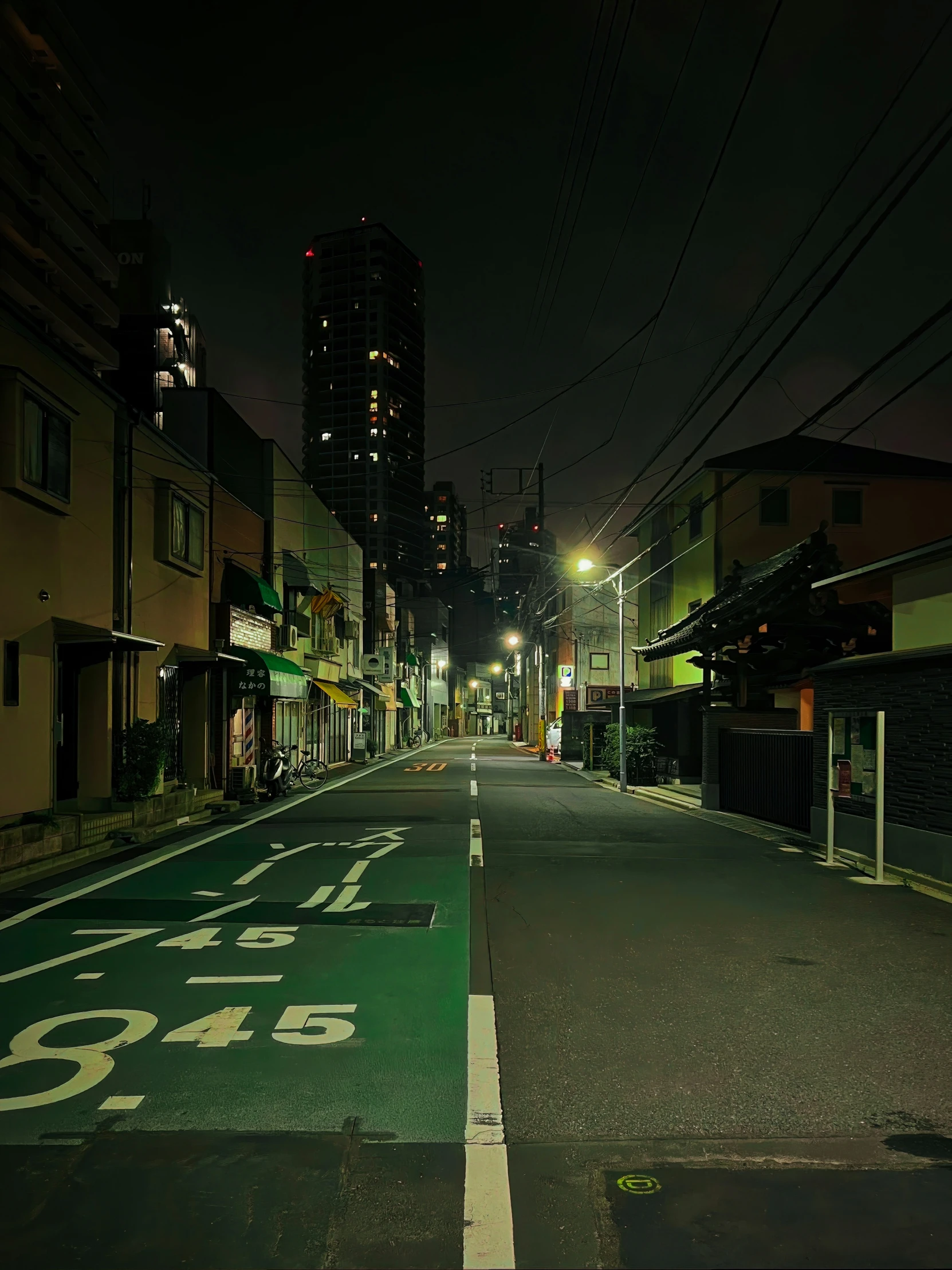 an empty street at night with buildings in the background