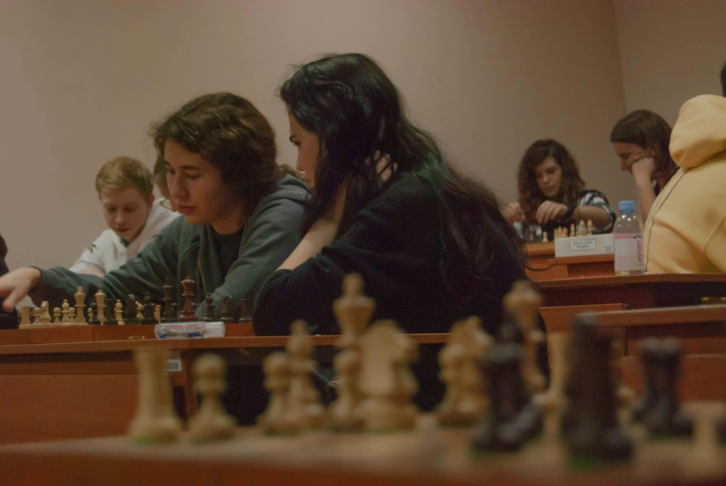 children play chess on the table in an classroom