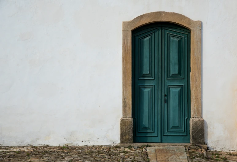 a green door in a building by itself