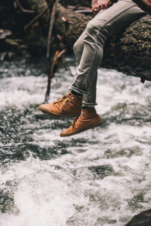 a person is standing on top of a rock next to water