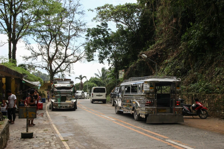 a number of buses parked on the side of a road