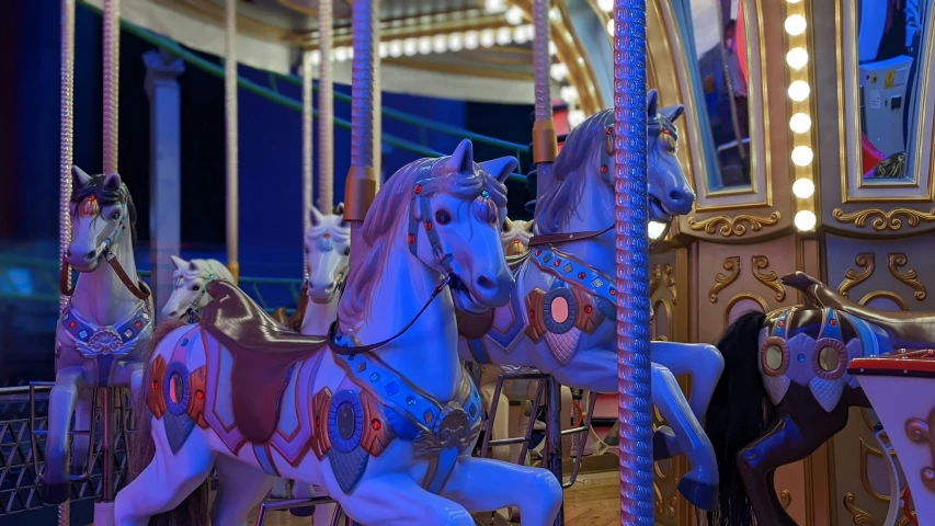 a close up of horses on a merry go round