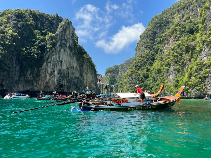 a small boat with two passengers sitting in the water