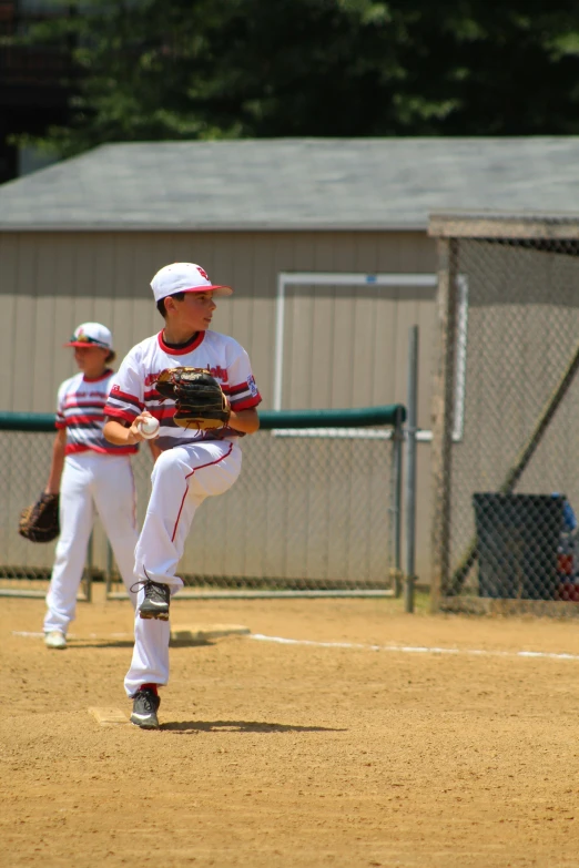 a man in a white and red uniform pitching