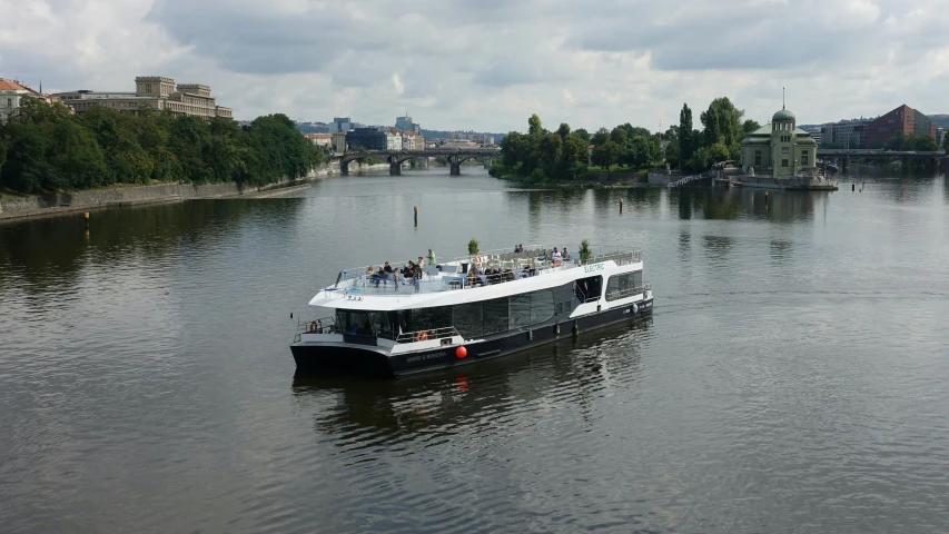 a large boat full of people floating down the river