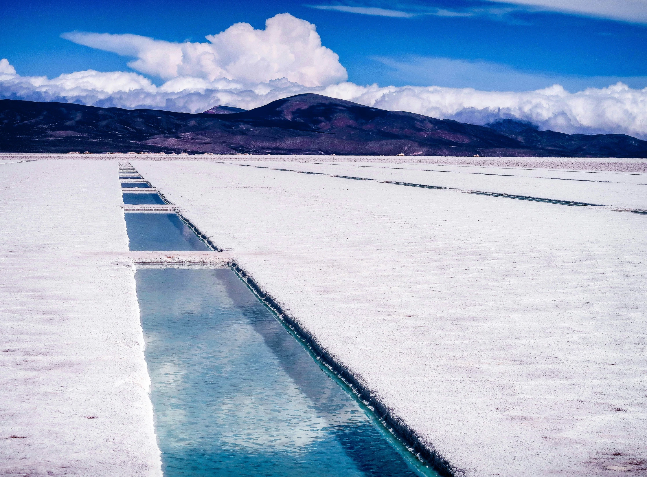 a large white body of water surrounded by mountains