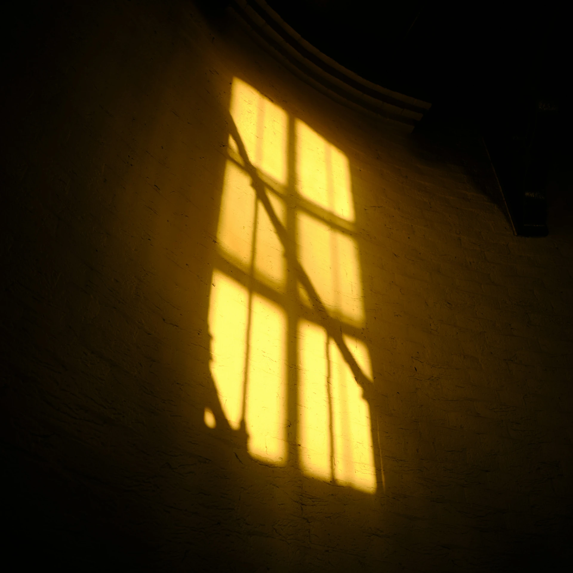 a person with their hand extended and shadow casting on the wall