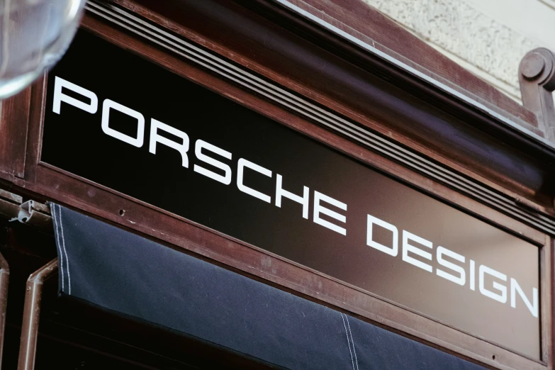 the porsche design storefront window is seen from the outside