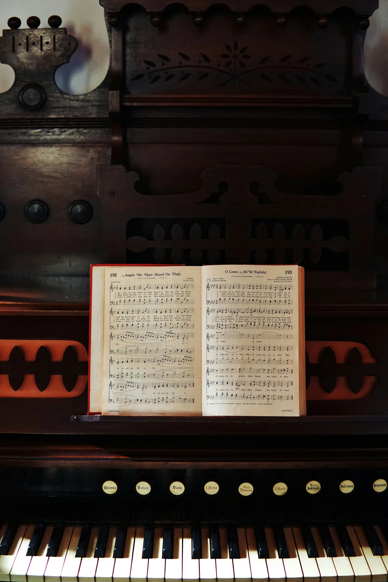 an old book sitting on top of a piano keyboard