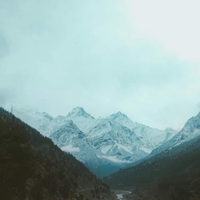 a mountain landscape shows mountains and a river