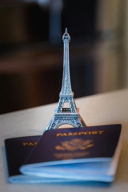 the small miniature model eiffel tower has a passport attached to it