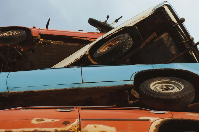 an orange car and blue truck side by side