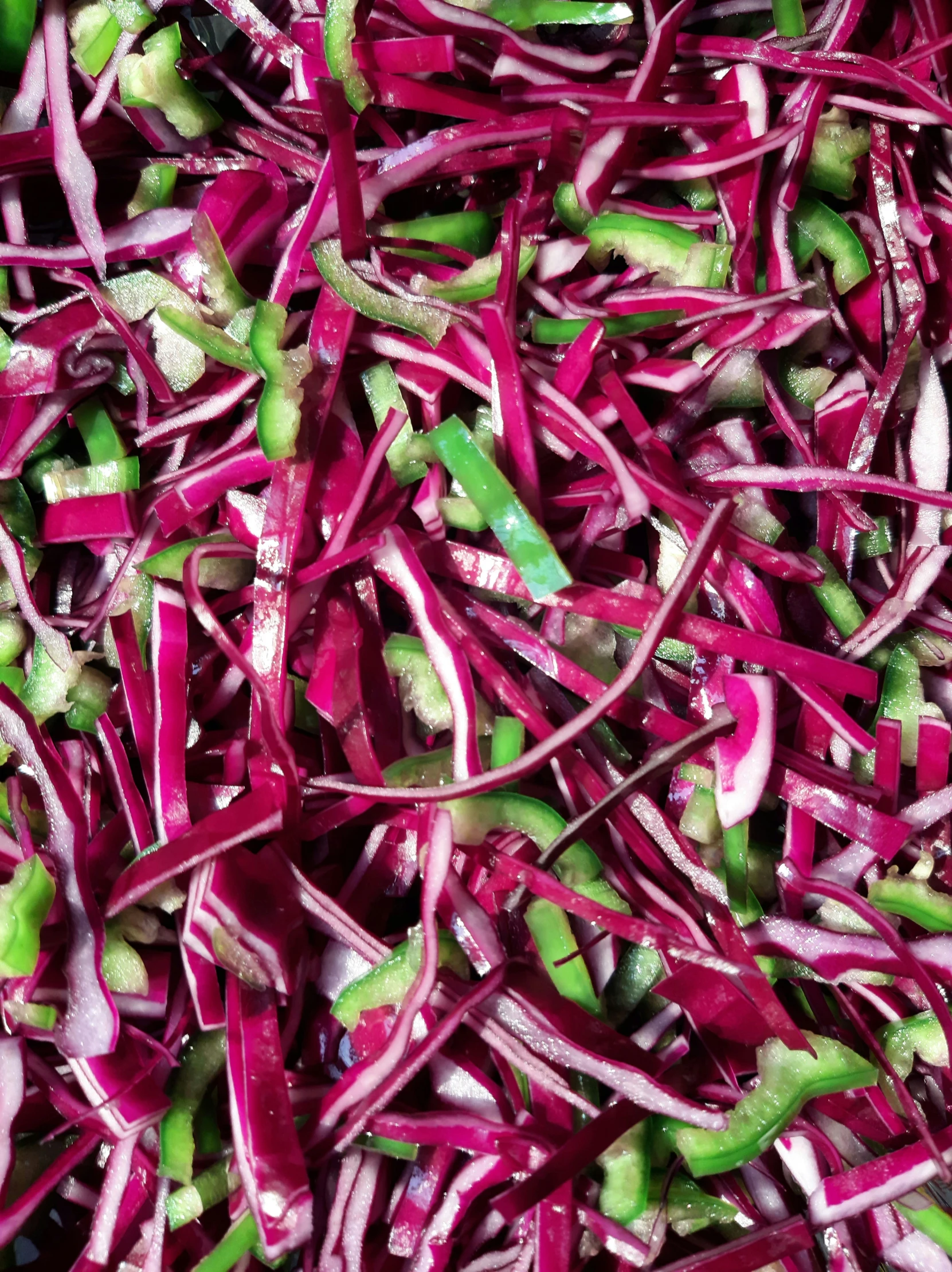 a pile of red coleslaw with bell peppers and green beans