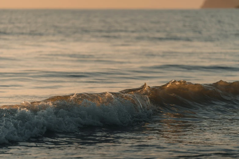 waves crashing on a beautiful beach during sunset