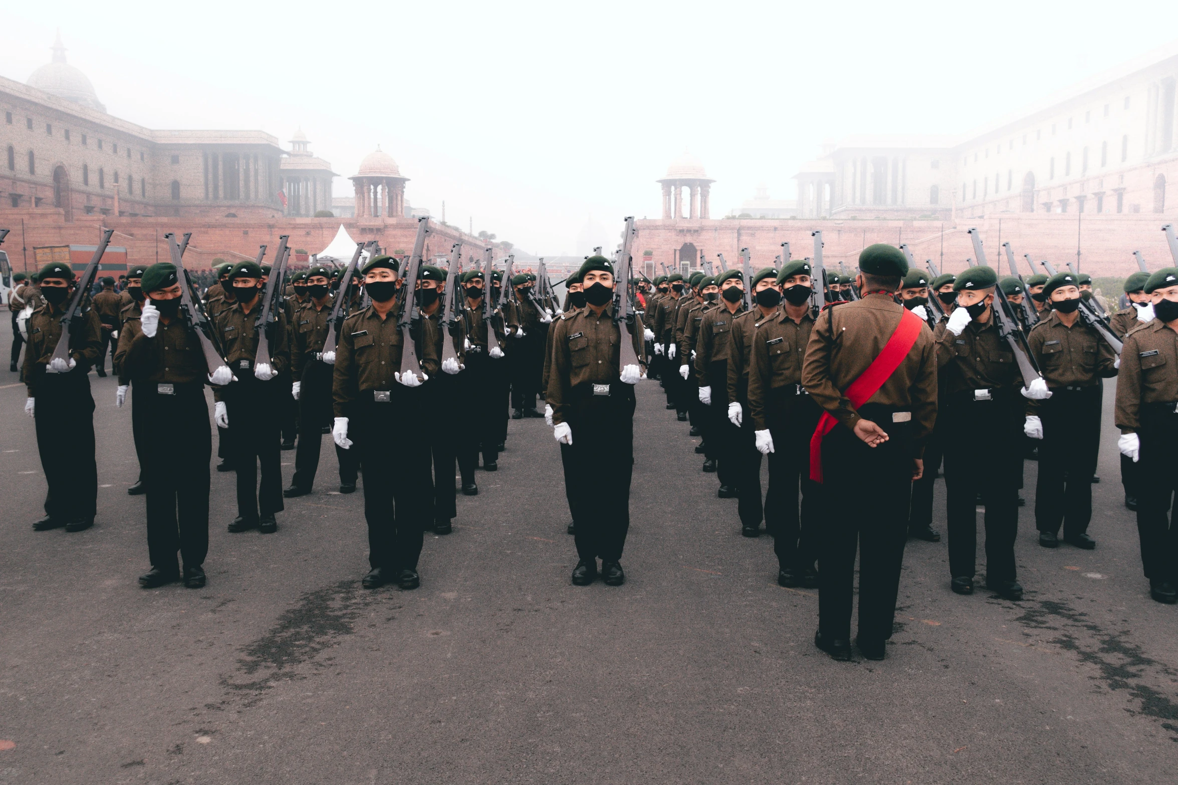 an armed parade marches through the streets in the city