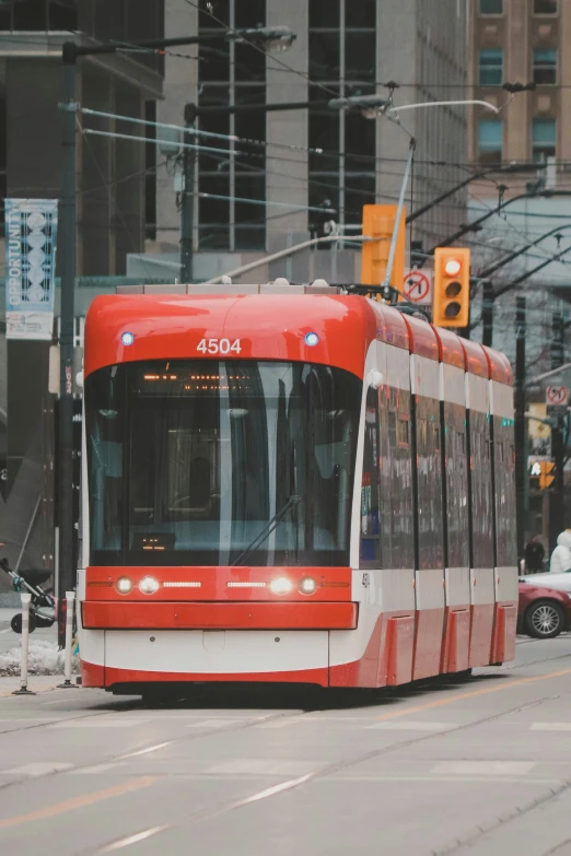 a trolley is on the street under wires