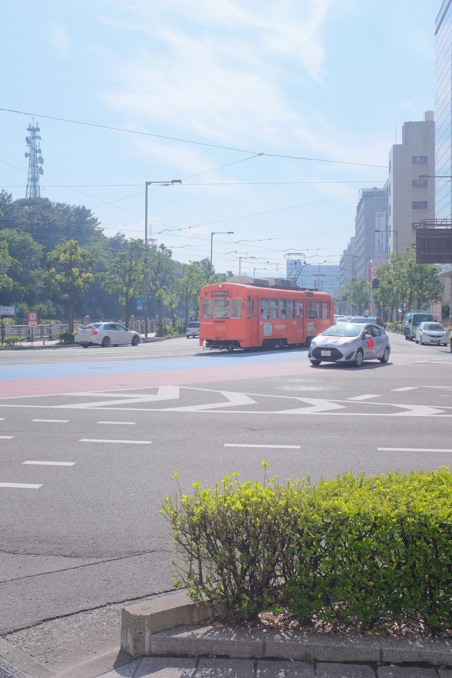 a red bus in a large parking lot