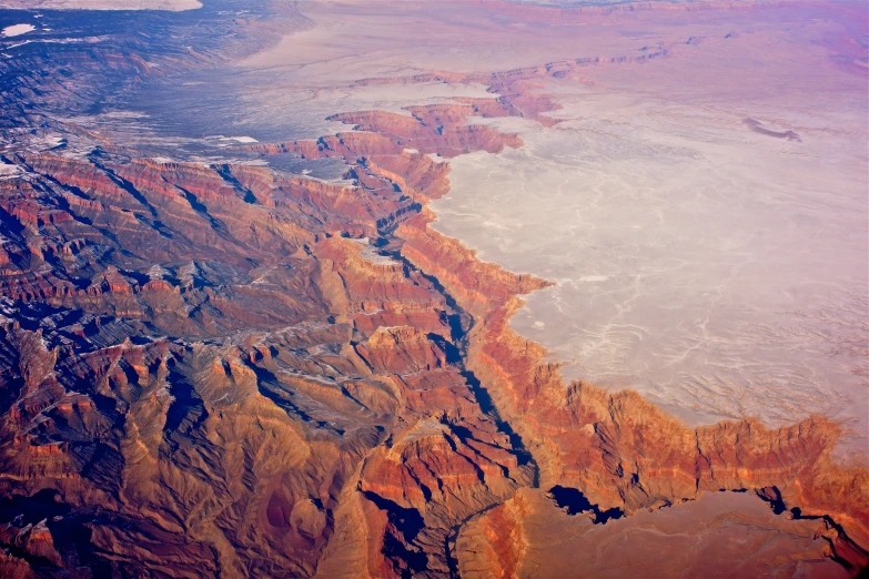 an aerial po taken from a plane looking down at a river and mountains