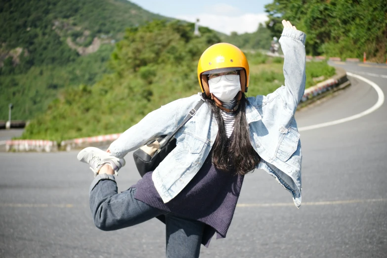 a young lady with a helmet riding her skateboard