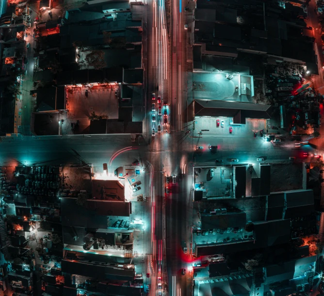 an aerial view of a street at night with many cars