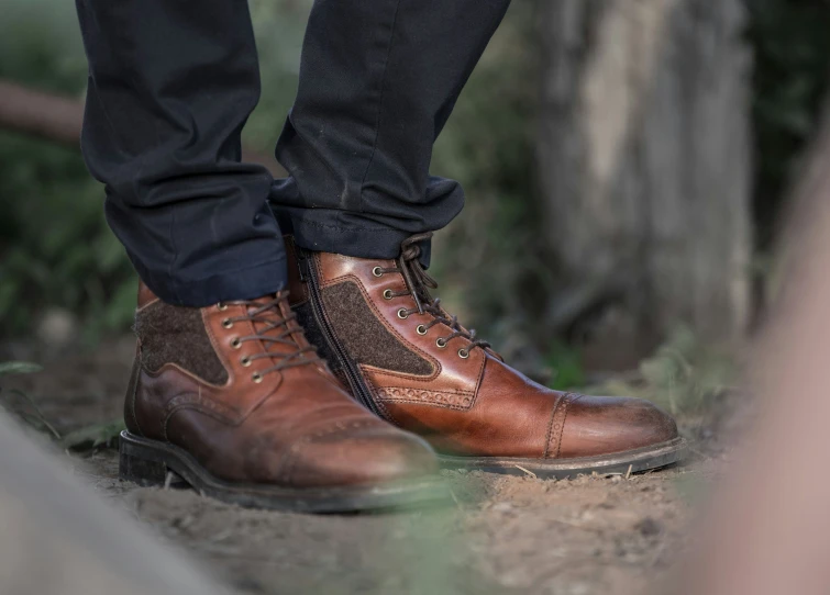 man's brown boots are seen from behind