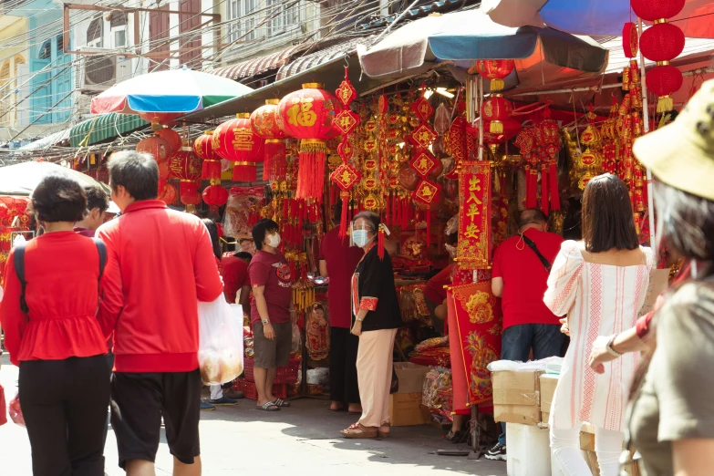 several people in the marketplace selling many items