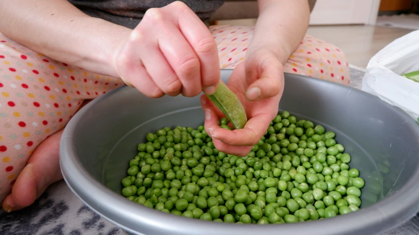 a person is putting peal into a bowl