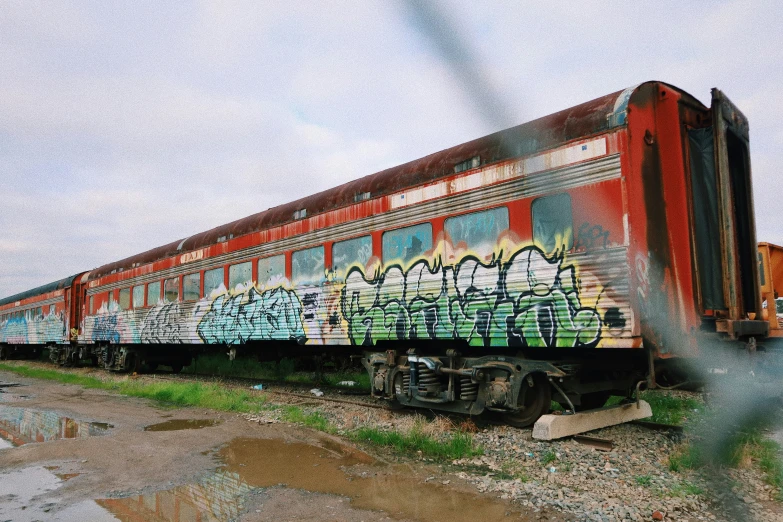 a colorful train with grafitti on the side