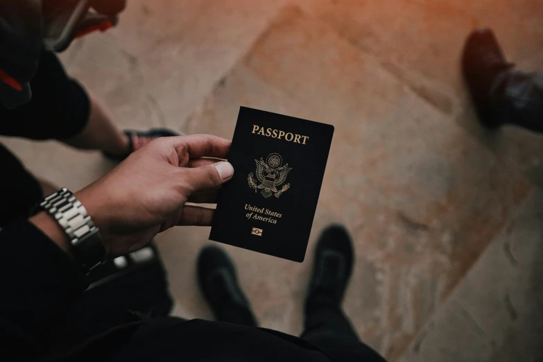 a person holding up a passport in front of their face