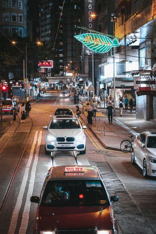 the cars are driving down the busy street