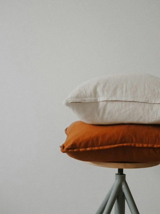 a stack of three pillows on a table