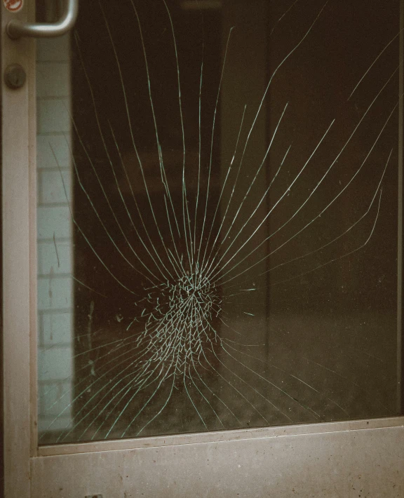the glass that is broken from a door on an exterior building