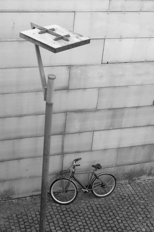 a bike is parked near a wall on the street