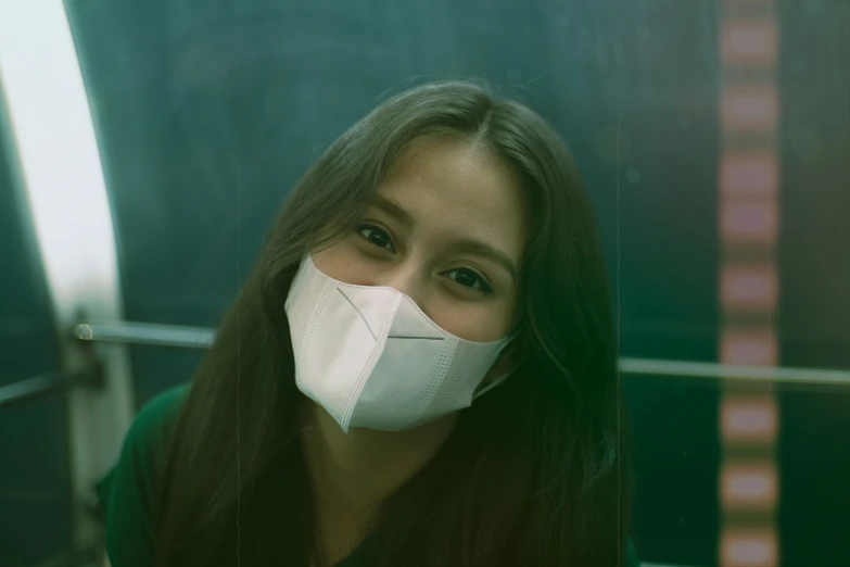 a girl wearing a face mask next to a building