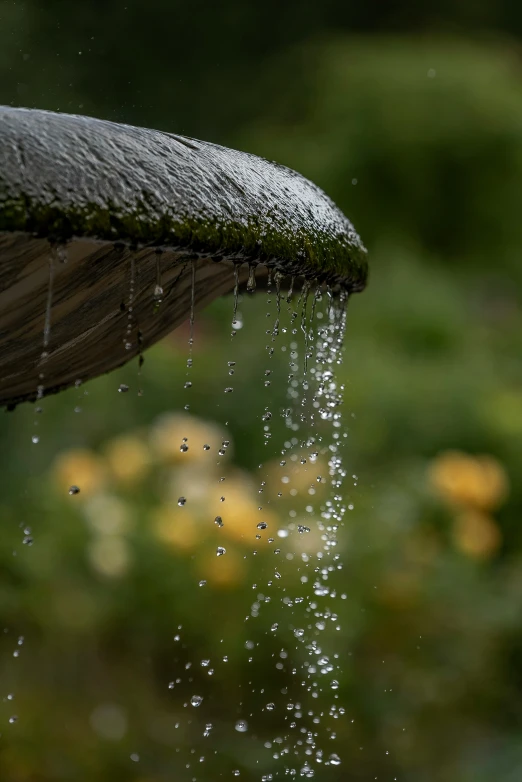 some rain is falling on the water from the faucet