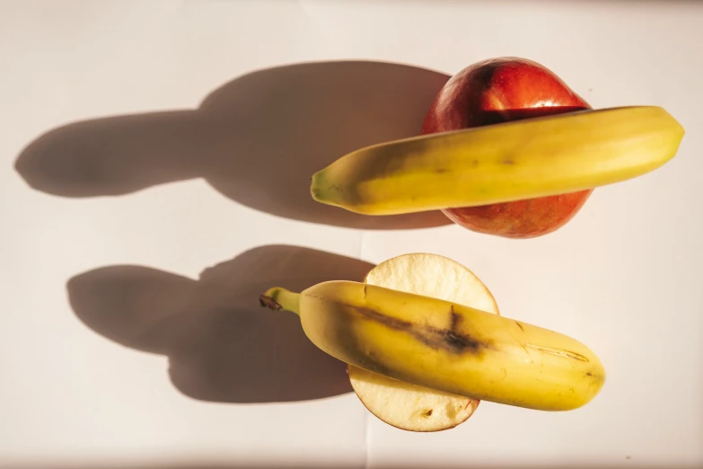 two pieces of fruit are next to an apple