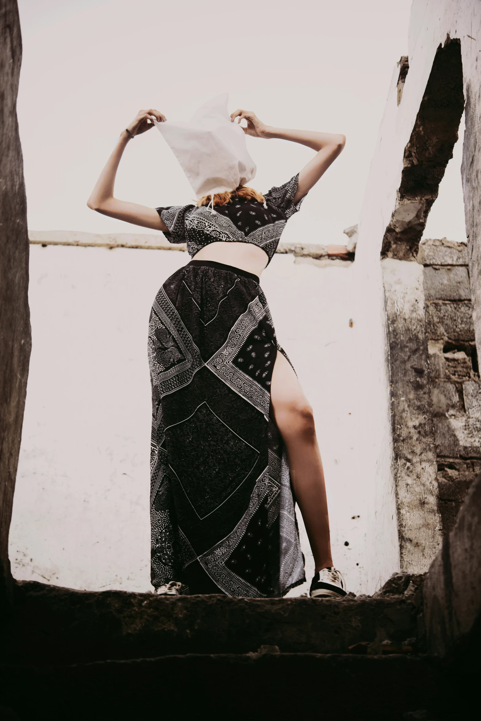 a girl with her back towards the camera wearing a hat