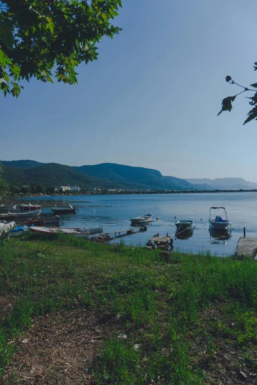 a body of water surrounded by land and a large lake with boats on it