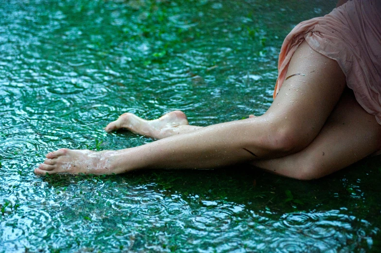 a woman lays in the water while looking back